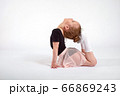 Little girl doing stretching and gymnastic exercises on a white background. 66869243
