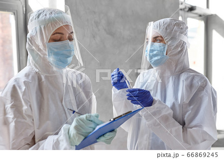 doctors in medical mask and shield with clipboard doctors in medical mask and shield with clipboard 66869245
