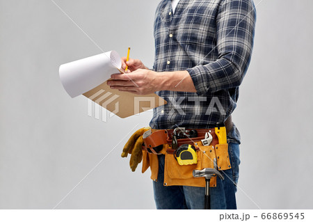 builder with clipboard, pencil and working tools 66869545