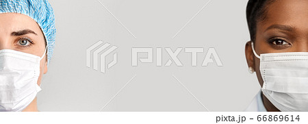 close up of doctor's faces in medical masks 66869614