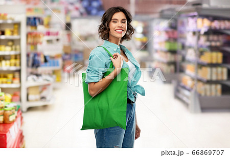 woman with reusable canvas bag for food shopping woman with reusable canvas bag for food shopping 66869707