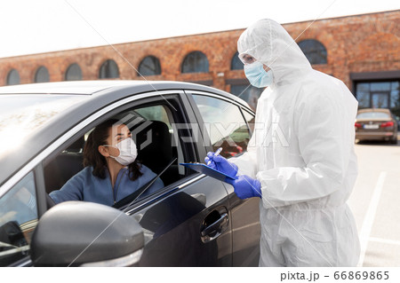healthcare worker with clipboard and woman in car healthcare worker with clipboard and woman in car 66869865