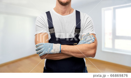 close up of male builder in overall and gloves close up of male builder in overall and gloves 66869876