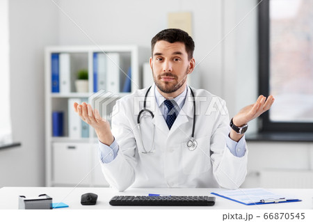 male doctor having video conference at hospital male doctor having video conference at hospital 66870545