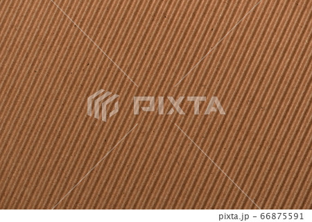 Corrugated light brown cardboard surface closeup 66875591