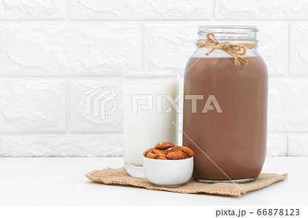 Milk Chocolate and Almonds in a glass on a white background Milk Chocolate and Almonds in a glass on a white background 66878123