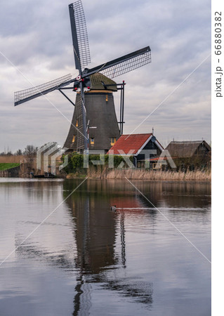 Dramatic cloudy sky over the famous Windmills in Kinderdijk Holland. Sunny summer evening at the windmill village countryside.Netherlands,UNESCO World Heritage Site. Kinderdijk Windmill village 66880382