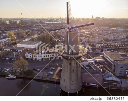 Beautiful windmill in Schiedam province South Holland, these highest windmill in the world also known as burner mills were used for grinding grain that was used for the Famous local Gin industry Beautiful windmill in Schiedam province South Holland, these highest windmill in the world also known as burner mills were used for grinding grain that was used for the Famous local Gin industry 66880435