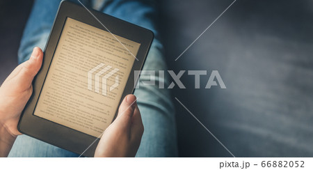 Girl is reading ebook on digital tablet device 66882052