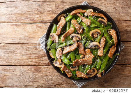 Tasty fried meat with mushrooms and pea pods, Tasty fried meat with mushrooms and pea pods, 66882577