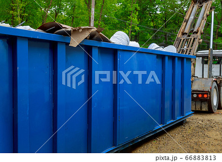 Truck loading a full recycling container trash Truck loading a full recycling container trash 66883813