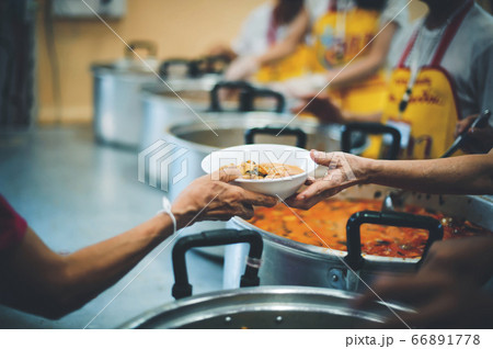 The donor gives warm food to the poor, concept of The donor gives warm food to the poor, concept of 66891778