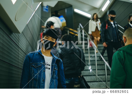 Man wear protective face mask in subway station with other people to protect Covid-19 virus 66892601