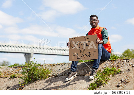 Volunteer sitting outdoors 66899312