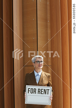 Businesswoman with placard outdoors Businesswoman with placard outdoors 66899586