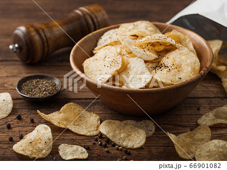 Black pepper taste potato crisps chips in wooden Black pepper taste potato crisps chips in wooden 66901082