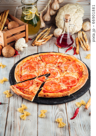 Margarita tomatoes pizza on the white wooden table Margarita tomatoes pizza on the white wooden table 66901881