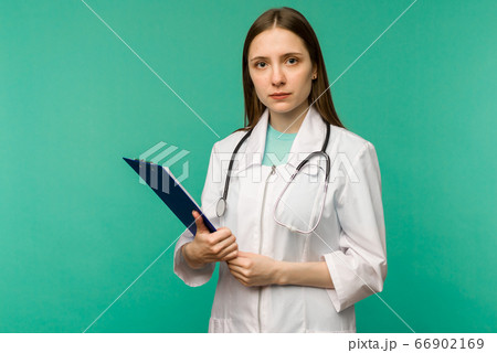 Happy smiling female doctor with clipboard, 66902169