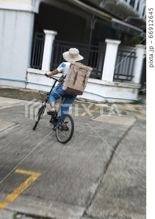 Woman riding black bicycle carrying boxes delivery Woman riding black bicycle carrying boxes delivery 66912645