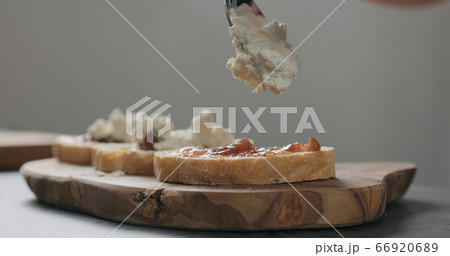 Slow motion man add ricotta to slice of ciabatta with fig marmalade and pancetta Slow motion man add ricotta to slice of ciabatta with fig marmalade and pancetta 66920689