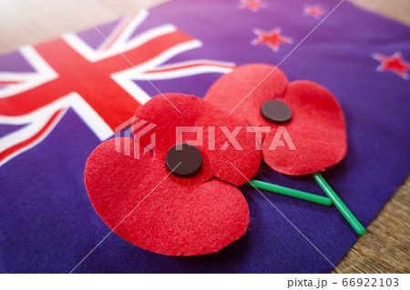 Close up on Remembrance poppies on a New Zealand flag. 66922103