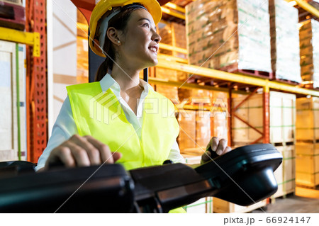 Asian warehouse worker with forklift in warehouse 66924147