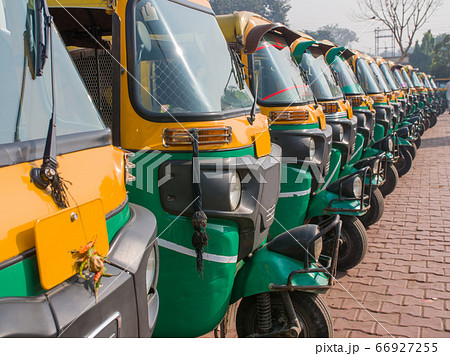 Yellow and green auto rickshaws in Indiya. Yellow and green auto rickshaws in Indiya. 66927255