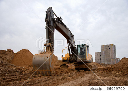 Track-type excavator during earthmoving at construction site. Track-type excavator during earthmoving at construction site. 66929700
