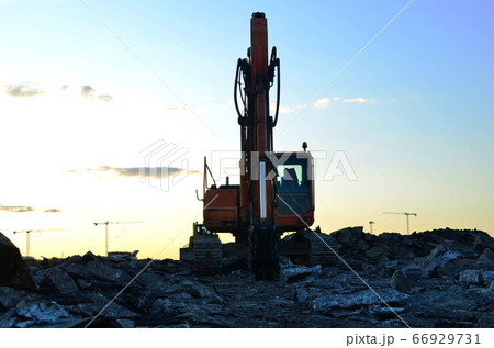 Large tracked excavator with hydraulic shears on a construction site Large tracked excavator with hydraulic shears on a construction site 66929731