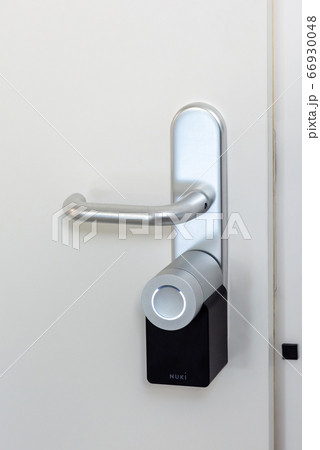 Entrance door being equipped with a Nuki Smartlock and open door detection . Concept of using smart electronic locks with keyless access. 66930048