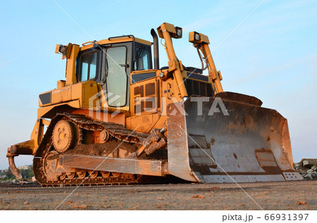Bulldozer during of large construction jobs at building site Bulldozer during of large construction jobs at building site 66931397
