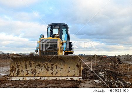 Bulldozer during of large construction jobs at building site. Bulldozer during of large construction jobs at building site. 66931409