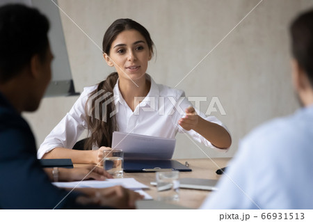 Confident Arabic businesswoman team leader giving instructions at briefing 66931513