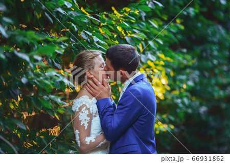 Elegant bride and groom posing together outdoors on a wedding day 66931862