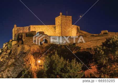 Walls and tower of Castle over rocky cliff at dusk in Marvao Walls and tower of Castle over rocky cliff at dusk in Marvao 66933205