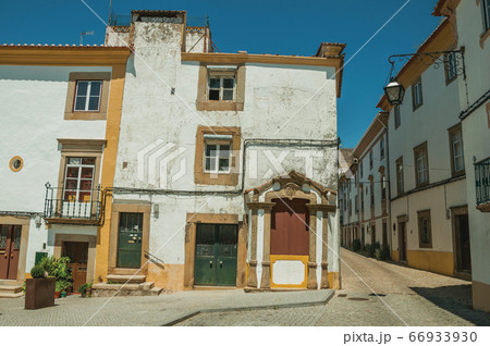 Old colorful house with worn plaster wall at Castelo de Vide 66933930