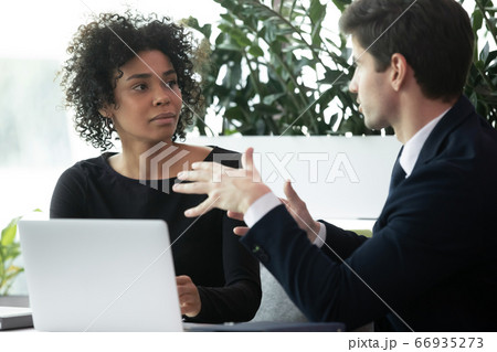 Diverse business man and woman working and discussing project together 66935273