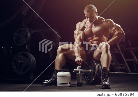 Bodybuilder with protein powder supplements jar Bodybuilder with protein powder supplements jar 66935594