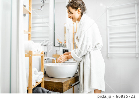 Woman washing hands at the bathroom 66935723