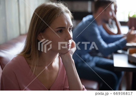 Lonely girl sit in cafe waiting boyfriend feels abandoned 66936817