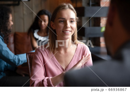 Woman participating in speed dating chatting with guy in cafe 66936867