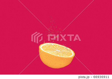 concept of an orange falling into water on a red, coral shiny background falls under water with bubbles 66936911