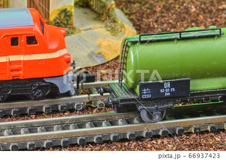 Railway tanker truck. Train hobby model on the model railway. Railroad platforms for transporting of liquid goods and products such as oil, gas, diesel. Close-up Railway tanker truck. Train hobby model on the model railway. Railroad platforms for transporting of liquid goods and products such as oil, gas, diesel. Close-up 66937423