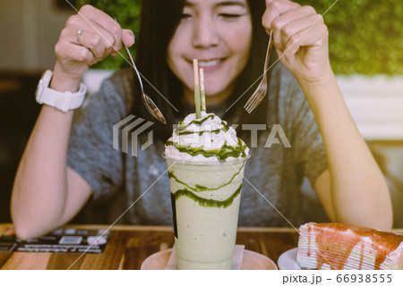 Happy asian woman drinking iced green tea at modern cafe,Relax time Happy asian woman drinking iced green tea at modern cafe,Relax time 66938555