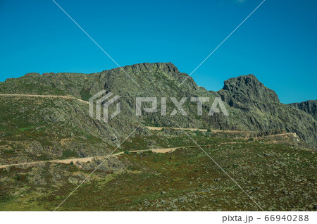 Roadway passing through rocky landscape 66940288