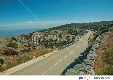 Roadway going through rocky landscape Roadway going through rocky landscape 66940289