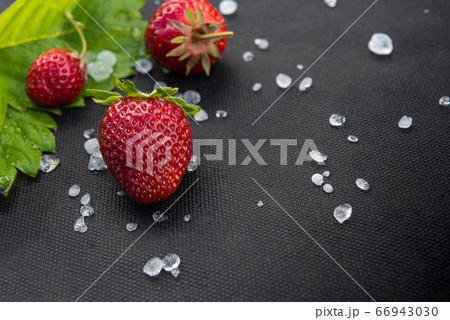 Close-up of ripe red strawberries on black surface 66943030