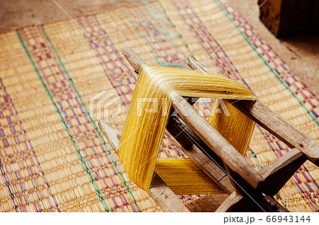 Yellow silk thread traditional sericulture of Thai silk making 66943144