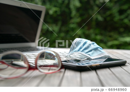 Work at home. Medical face mask on top of computer 66948960
