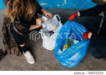 Two young women sorting garbage. Concept of recycling. Zero waste 66952019